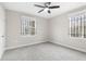 Neutral bedroom with carpet flooring, ceiling fan and windows with security bars at 1104 Oak Knoll Se Ter, Atlanta, GA 30315