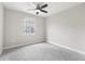 Neutral bedroom with ceiling fan, carpet flooring and windows with security bars at 1104 Oak Knoll Se Ter, Atlanta, GA 30315
