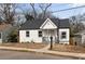 Charming bungalow featuring a fresh white paint scheme and a well-manicured lawn at 1104 Oak Knoll Se Ter, Atlanta, GA 30315