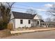 Bungalow featuring a fresh white paint scheme, dark roof, and a small front yard at 1104 Oak Knoll Se Ter, Atlanta, GA 30315