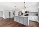 Bright open kitchen featuring stainless appliances, a kitchen island, and wood-look floors at 1104 Oak Knoll Se Ter, Atlanta, GA 30315