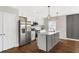 Bright kitchen with stainless steel appliances, island with seating, and white cabinetry at 1104 Oak Knoll Se Ter, Atlanta, GA 30315