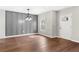 Open living room featuring new gray wainscotting and warm wood-look vinyl floors at 1104 Oak Knoll Se Ter, Atlanta, GA 30315