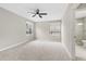 Large main bedroom showcasing carpet flooring, ceiling fan and ensuite bathroom at 1104 Oak Knoll Se Ter, Atlanta, GA 30315