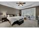 Serene primary bedroom with tray ceiling, plush carpet and large windows at 1460 Badingham Dr, Cumming, GA 30041