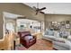 Spacious living area connects to the kitchen and dining area, highlighted by hardwood floors and a fireplace at 1460 Badingham Dr, Cumming, GA 30041