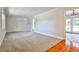 Spacious living room featuring neutral carpet, white trim, and natural light at 3549 Creatwood Se Trl, Smyrna, GA 30080