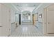 Bathroom with soaking tub under large arched window, white tile floor, and vanity area at 510 Covington Cv, Alpharetta, GA 30022