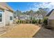 Spacious back yard featuring dormant sod, surrounded by a wood fence with neighboring houses in the background at 1030 Whistling Swan Pl, Marietta, GA 30066