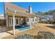 Backyard featuring a covered patio with outdoor seating and a well-kept lawn at 1030 Whistling Swan Pl, Marietta, GA 30066