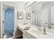 Well-lit bathroom with a large mirror, white vanity, and a shower featuring a patterned curtain at 1030 Whistling Swan Pl, Marietta, GA 30066