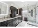 Elegant bathroom with double vanity, modern fixtures, updated shower and dark cabinets with marble countertops at 1030 Whistling Swan Pl, Marietta, GA 30066