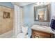 Well-lit bathroom featuring a shower with tile surround, vanity with granite counters, and blue painted walls at 1030 Whistling Swan Pl, Marietta, GA 30066