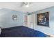 A cozy bedroom features blue walls, hardwood floors, and a ceiling fan at 1030 Whistling Swan Pl, Marietta, GA 30066