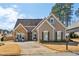 Charming single Gathering home with stone accents, manicured lawn, and two-car garage at 1030 Whistling Swan Pl, Marietta, GA 30066