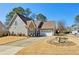 Charming single Gathering home with stone accents, manicured lawn, and two-car garage at 1030 Whistling Swan Pl, Marietta, GA 30066