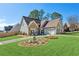 Charming single Gathering home with stone accents, manicured lawn, and two-car garage at 1030 Whistling Swan Pl, Marietta, GA 30066