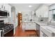 Bright kitchen with stainless steel appliances, marble counters, and ample cabinet space at 1030 Whistling Swan Pl, Marietta, GA 30066
