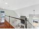 Landing that overlooks the living room, hardwood flooring, and white railings with black accents at 1030 Whistling Swan Pl, Marietta, GA 30066