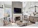 Relax in this cozy living room with a fireplace, window seating, and plush furnishings at 1030 Whistling Swan Pl, Marietta, GA 30066