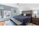 Comfortable main bedroom featuring a large bed, wooden accents, a ceiling fan, and soft blue walls at 1030 Whistling Swan Pl, Marietta, GA 30066