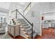 Bright staircase with carpeted steps, wooden rails, and a view of the kitchen at 1030 Whistling Swan Pl, Marietta, GA 30066
