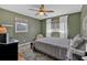 Comfortable bedroom with sage green walls, ceiling fan, and a relaxing atmosphere at 161 Diane Se Dr, Smyrna, GA 30082