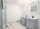 Contemporary bathroom featuring double sinks, new fixtures, and a tiled shower at 2178 Penelope Nw St, Atlanta, GA 30314