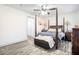 Bedroom with four-poster bed, ceiling fan, wood-look floors and light-filled windows at 2178 Penelope Nw St, Atlanta, GA 30314