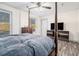 Cozy bedroom with ceiling fan, wood-look floors, and light-filled windows at 2178 Penelope Nw St, Atlanta, GA 30314
