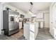 Well-lit kitchen showcasing stainless appliances, island, and view into adjacent rooms at 2178 Penelope Nw St, Atlanta, GA 30314