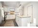Bright kitchen with white cabinets, granite countertops, island and stainless refrigerator at 2178 Penelope Nw St, Atlanta, GA 30314