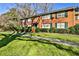 The exterior elevation featuring a brick facade, green shutters, and a well-maintained lawn with mature trees at 425 Lindbergh Ne Dr # A2, Atlanta, GA 30305
