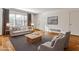 Inviting living room featuring hardwood floors, a cozy couch, and large windows for natural light at 425 Lindbergh Ne Dr # A2, Atlanta, GA 30305