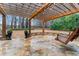 Outdoor patio featuring a wooden swing, string lights, and manicured landscaping at 1110 Eagles Brooke Dr, Locust Grove, GA 30248