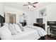 Bedroom features a comfortable bed, ceiling fan, dark wood floors and a large window at 400 17Th Nw St # 2427, Atlanta, GA 30363