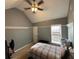 Neutral bedroom with a ceiling fan, dormer window and comfortable furnishings at 405 Sycamore Trl, Woodstock, GA 30189