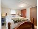 Comfortable bedroom with a wooden frame bed, soft lighting, and closet storage at 209 Sweetwater Trl, Villa Rica, GA 30180