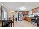 Well-lit kitchen with stainless steel appliances, wood cabinets, and eat in dining space at 209 Sweetwater Trl, Villa Rica, GA 30180