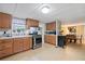 An eat-in kitchen with wood cabinets, stainless steel appliances, and adjacent dining area at 209 Sweetwater Trl, Villa Rica, GA 30180