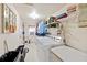 Bright laundry room with washer, dryer, and shelving for storage at 209 Sweetwater Trl, Villa Rica, GA 30180