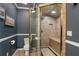 Bathroom featuring a tiled shower with a glass door, a built-in seat, and a tiled floor at 4095 Oberon Se Ct, Smyrna, GA 30080