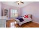 bedroom features hardwood floors, neutral walls, and a large window at 4095 Oberon Se Ct, Smyrna, GA 30080