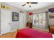 Bedroom featuring hardwood floors, sports decor and a window with plantation shutters at 4095 Oberon Se Ct, Smyrna, GA 30080