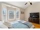 Cozy bedroom with vaulted ceiling features natural light, a ceiling fan, and hardwood floors at 4095 Oberon Se Ct, Smyrna, GA 30080