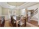 Elegant dining room featuring hardwood floors, a chandelier, decorative molding and views into the foyer at 4095 Oberon Se Ct, Smyrna, GA 30080