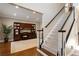 Inviting foyer with staircase and a view of the office which features hardwood floors and custom built-ins at 4095 Oberon Se Ct, Smyrna, GA 30080
