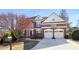 Charming two-story red brick home boasts a well-manicured lawn and a two-car garage with basketball hoop at 4095 Oberon Se Ct, Smyrna, GA 30080