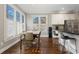 Eat-in kitchen with stainless steel appliances, island with breakfast bar, white cabinets, and hardwood floors at 4095 Oberon Se Ct, Smyrna, GA 30080