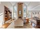 Spacious living room boasts a soaring ceiling, stone fireplace, hardwood floors, and custom built-in shelving at 4095 Oberon Se Ct, Smyrna, GA 30080